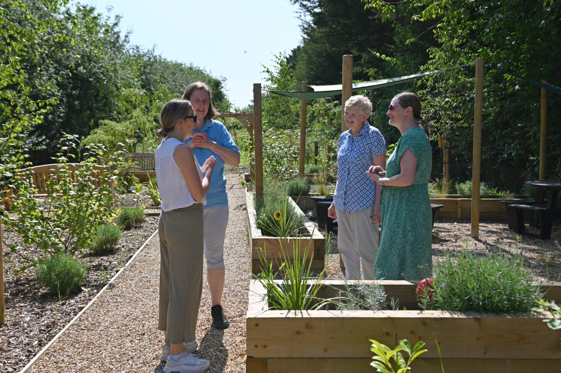 PEM and Sunflowers team meet in their new accessible garden after PEM donated £500 to build the new space.