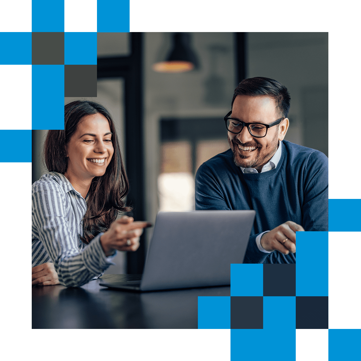 Man and woman in discussion, looking at computer