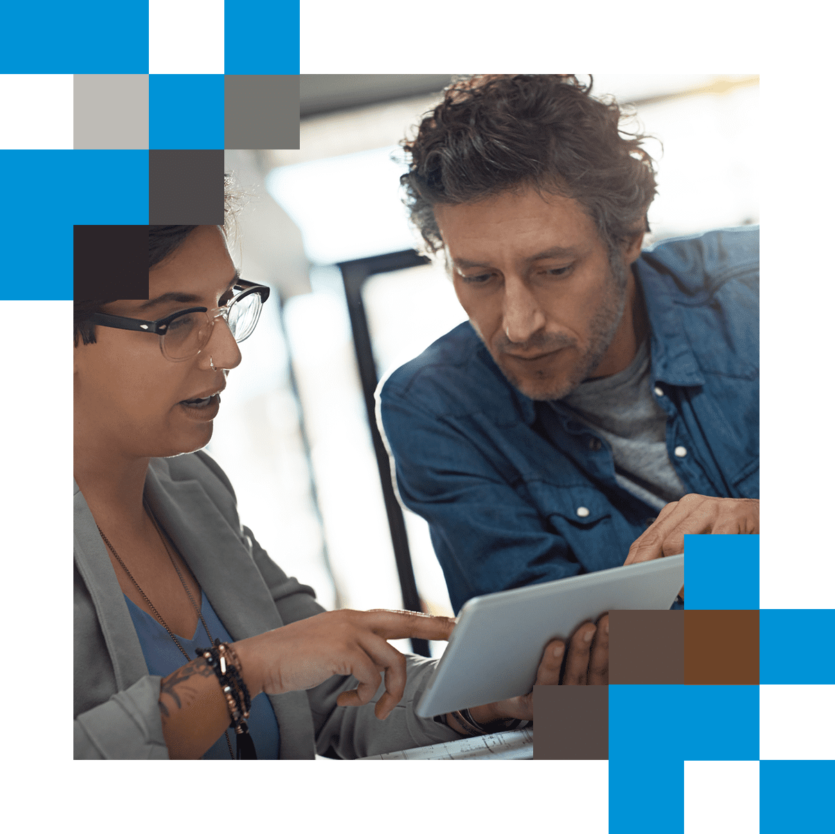 Man and woman in discussion looking at tablet