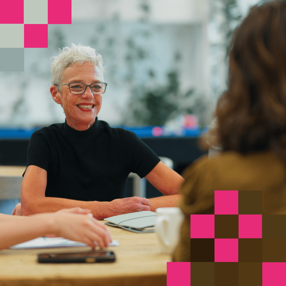 Woman talking to employee across the table about the Charities SORP changes